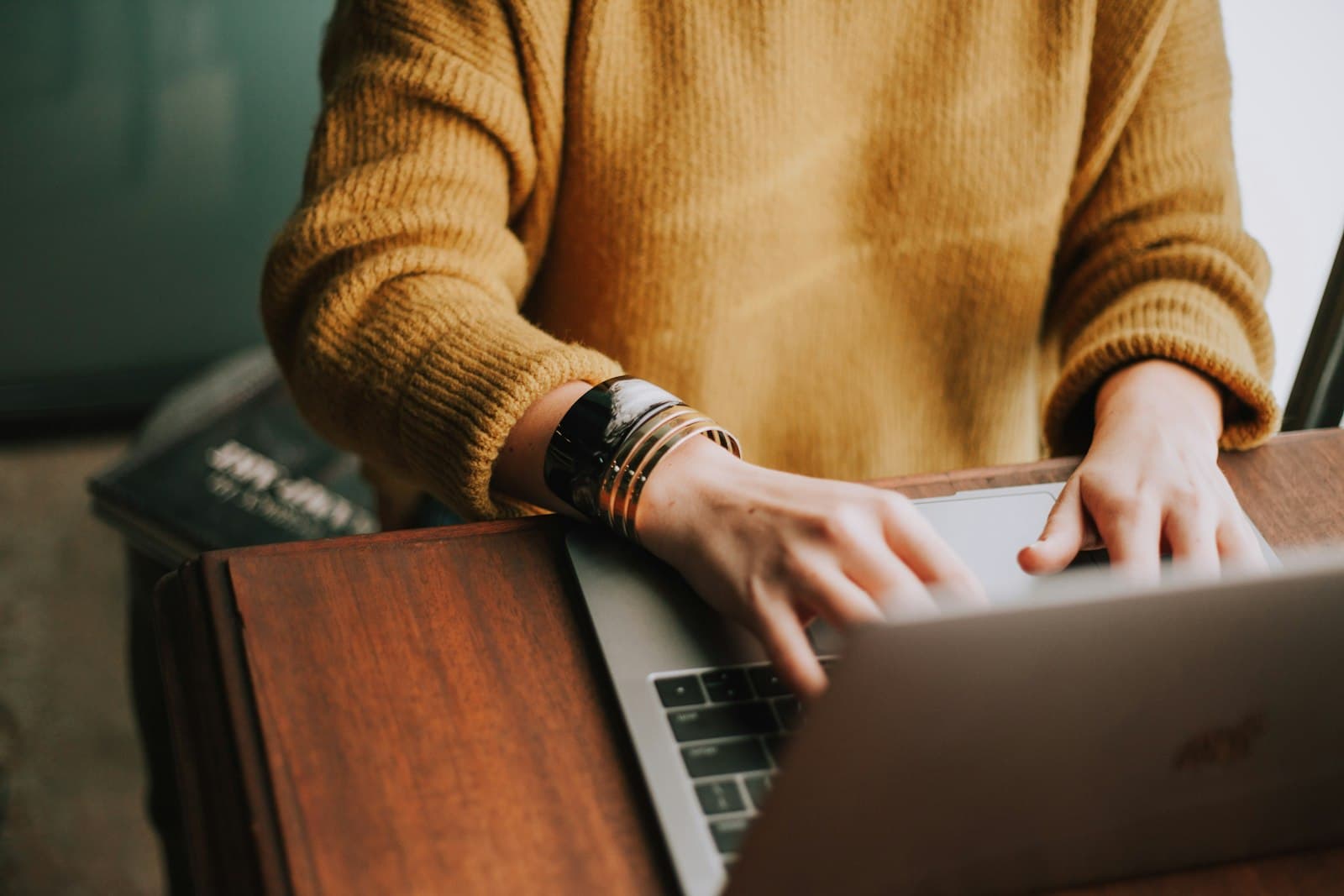 A person at a laptop, focused on the human work behind the technology