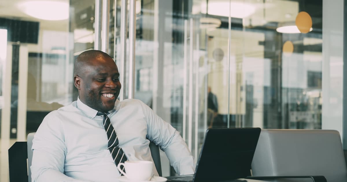 Someone laughing at their desk. The goal is not to replace anyone.