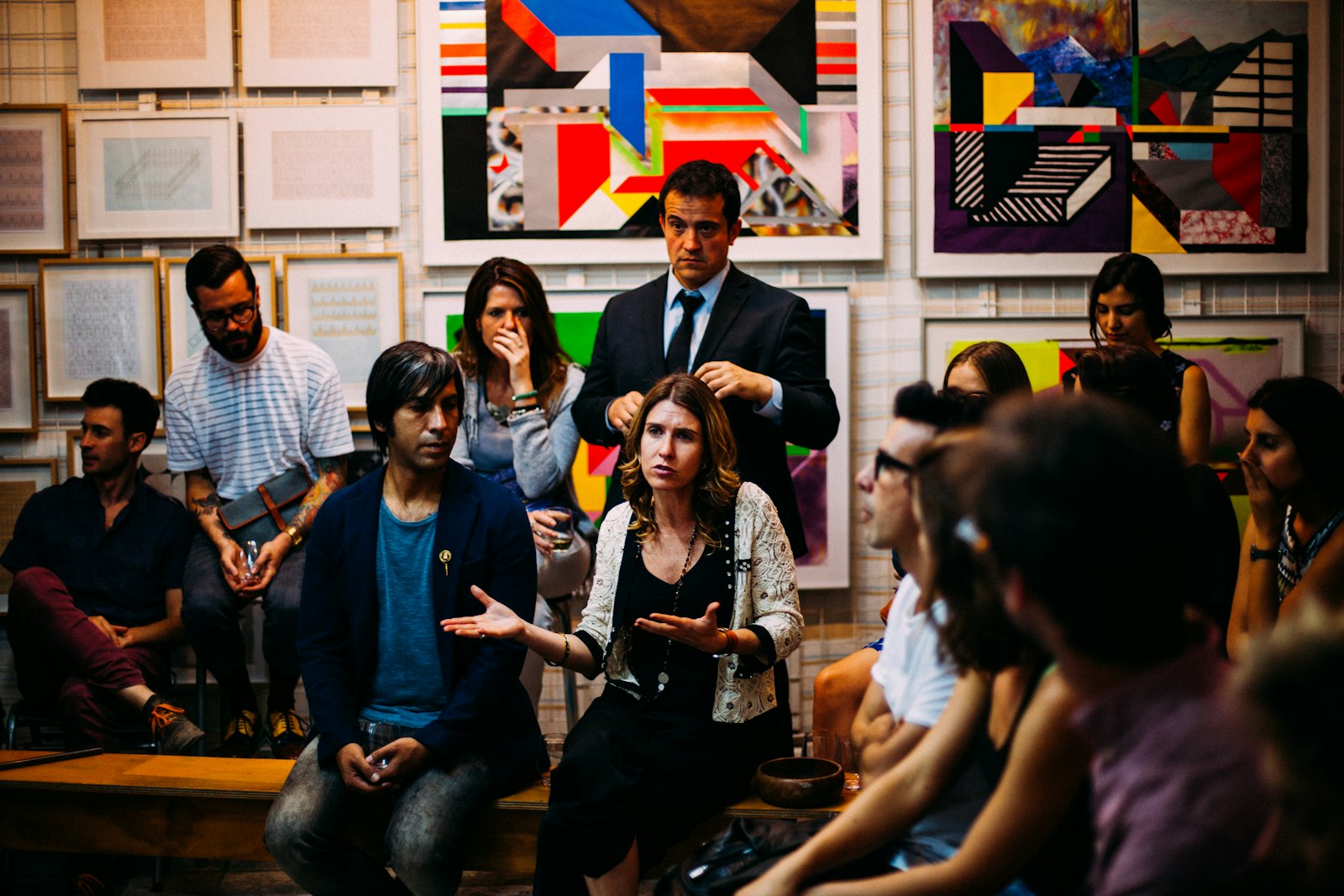 A group of AI professionals around a wooden table at a community meetup, learning from peers