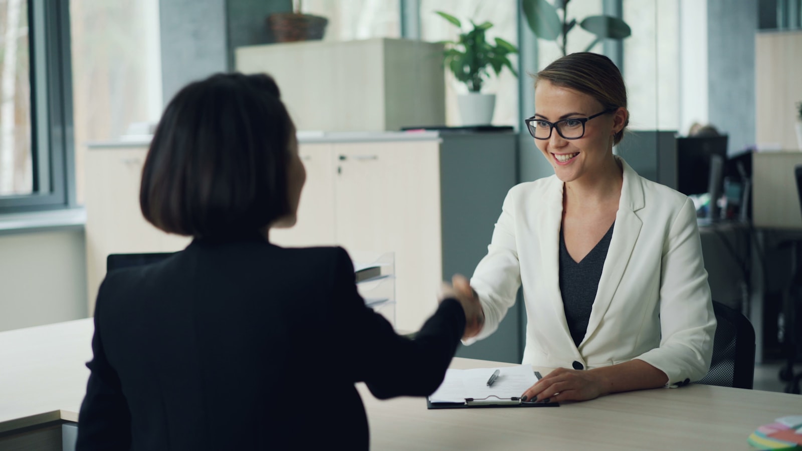 Two people in a real conversation across a desk, connection is where APAC lands